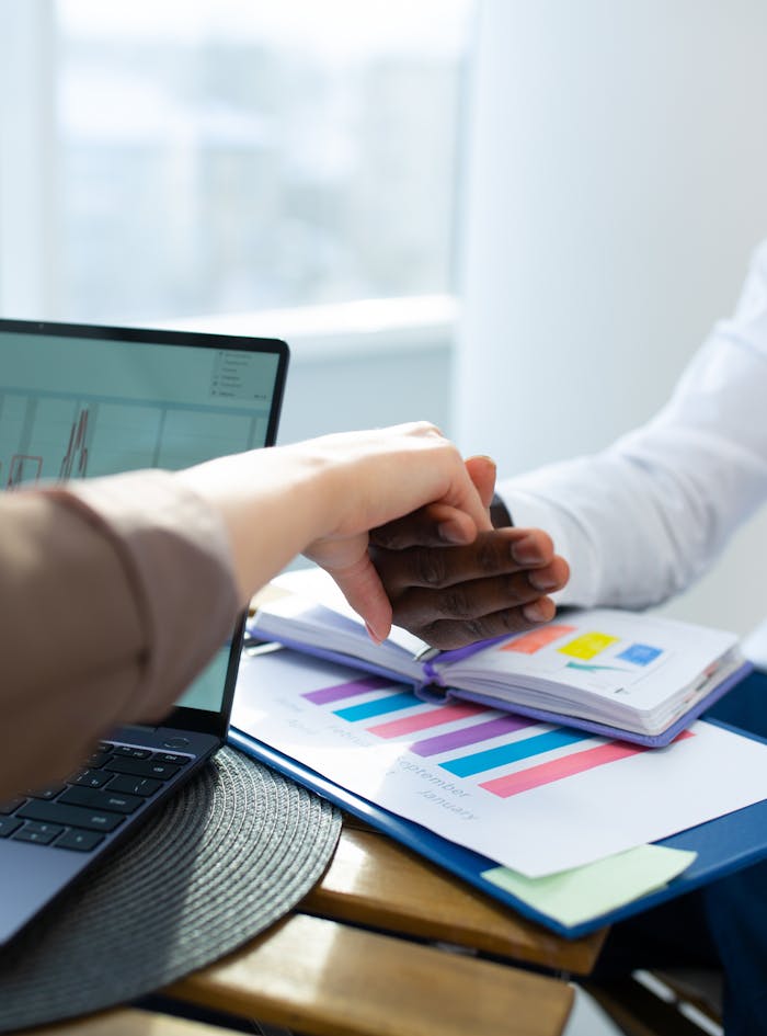 pexels-photo-6931338 Office colleagues engaging in a handshake during a productive meeting, showcasing teamwork and collaboration.